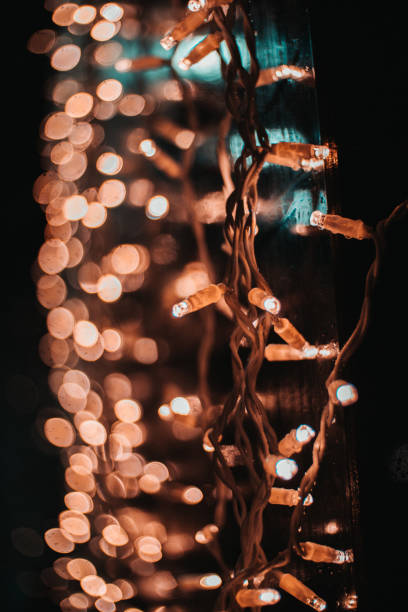 istock Vertical shot of beautiful string lights with bokeh lights in the background 1455921083