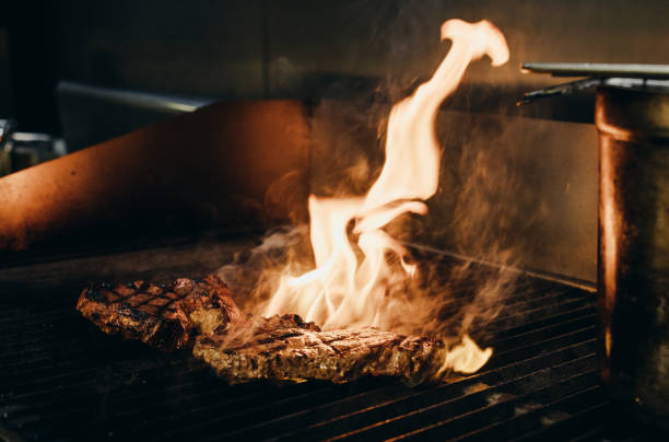 istock Closeup shot of a burning fire on a grill with meat 1455921268