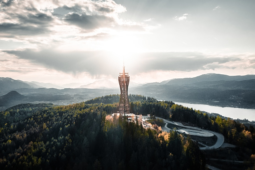 An aerial view of the Pyramidenkogel Tower in Keutschach am See, Austria at sunset or sunrise
