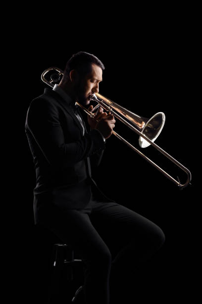istock Man playing a trumpet and sitting on a chair 1455922340
