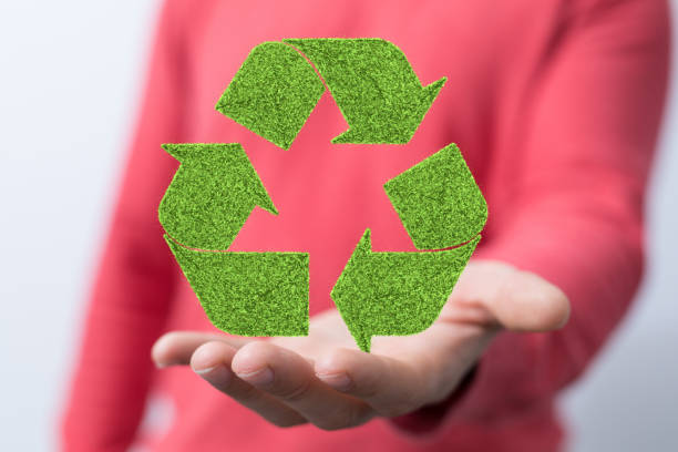istock Caucasian hand holding green recycle symbol 1455922351