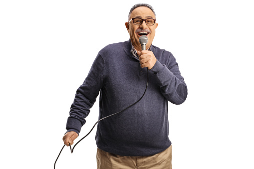 Happy mature man singing with a microphone isolated on white background