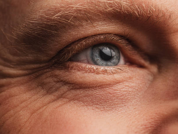 Eye - Macro skin and face detail with wrinkles on mature man stock photo