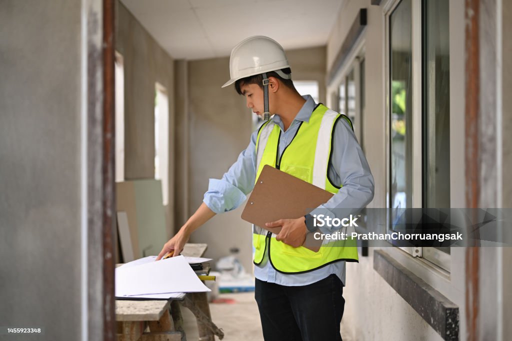 Development Plan Engineer Asian Engineer Man Planning Development Details Examining Plans At ...