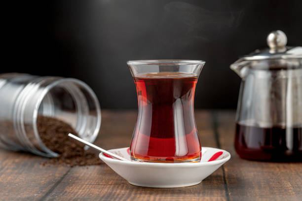 Freshly brewed turkish tea in thin-waisted glass cup on wooden table
