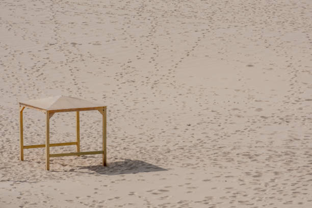 A closeup of a pavilion on a sand