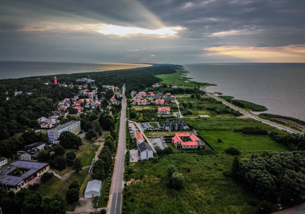 istock Aerial view of a town between seas under cloudy sky in sunset 1455927394