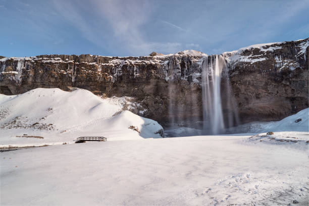istock Waterfall and a river flowing through the snow in winter 1455927451