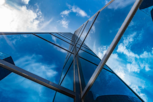 istock Low angle shot of a glass building on cloudy sky background 1455928156