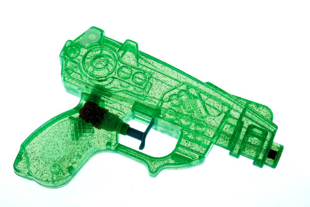 istock Closeup of a green plastic water gun on a white background 1455929545