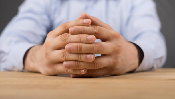istock Closeup of hands on the wooden table 1455929921
