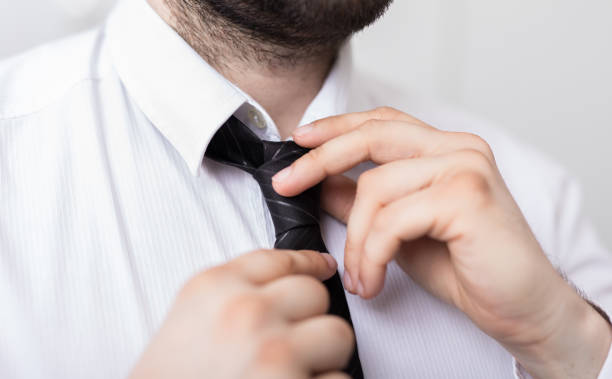 istock Closeup of a man tying his tie 1455929978