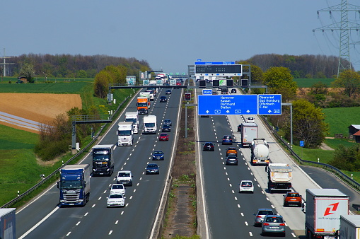 Frankfurt, Germany – April 28, 2021: German motorway A5 in spring north of Frankfurt. Sunny with motion blur.