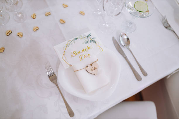 A white table with dishware and wedding decorations at the restaurant