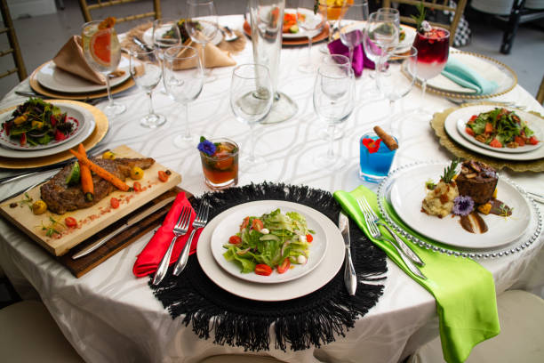 istock Laid table with vegetables, salads and drinks. Festive table with food. Elegant celebration dinner 1455932969