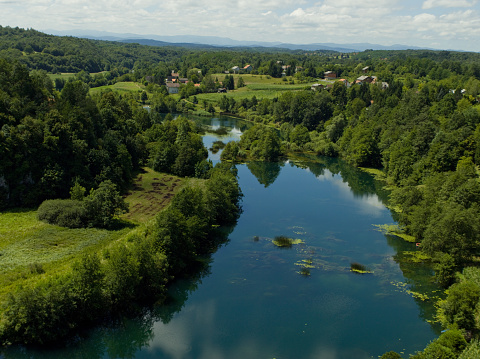 A landscape of The Mreznica surrounded by greenery on a sunny day in Karlovac County, Croatia
