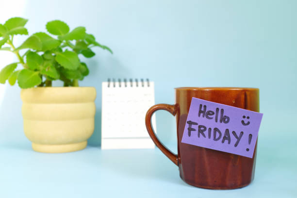 istock Welcome, hello and happy Friday concept. Selective focus of coffee cup with purple paper note and written message. 1455935879