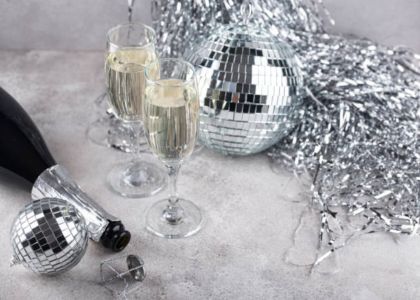 istock Glass of champagne with disco ball. 1455936704