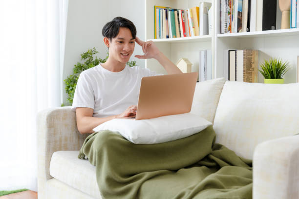 istock Man shopping online at home. 1455938190