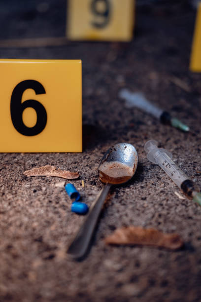 istock Drug addiction, pills, syringe and spoon. 1455939725