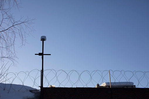 Barbed wire fence. Details of industrial area. Protection made of dangerous wire.