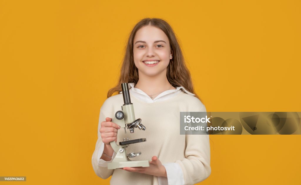 positive kid with microscope on yellow background positive kid with microscope on yellow background. High School Stock Photo