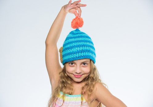 Free knitting patterns. Fall winter season accessory. Childrens knitted hats. Girl long hair happy face white background. Kid wear warm soft knitted blue hat. Difference between knitting and crochet.