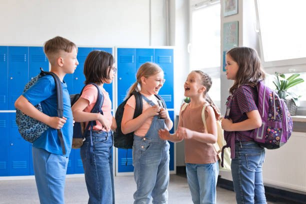istock School children talking in the school corridor 1455946347