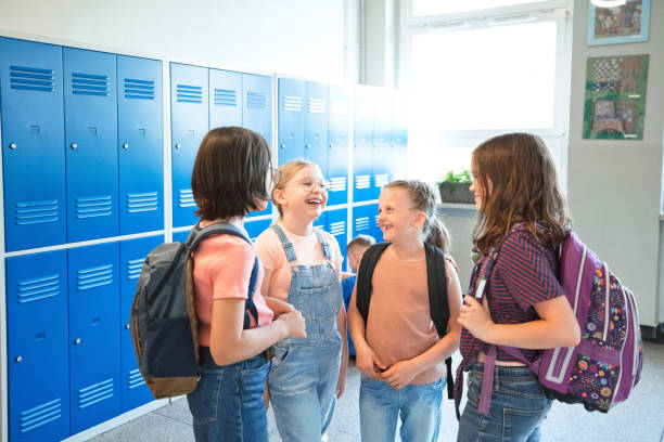 istock School girls talking in the school corridor 1455946874