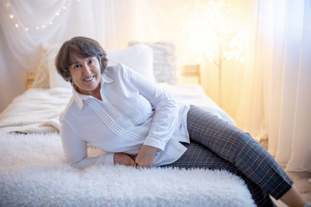 istock Elderly woman, posing at home, sitting on sofa or bed 1455947565
