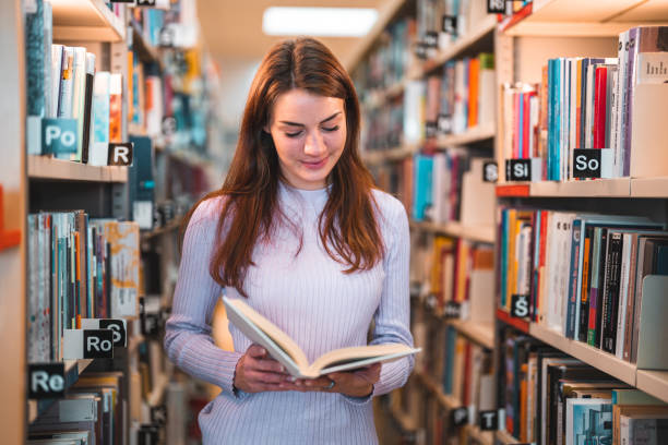 istock Caucasian Female Reading In A Library 1455947887
