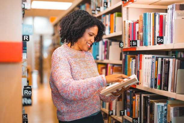 istock Mid Adult Hispanic Female Flipping Through A book 1455947899