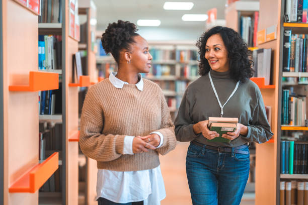 istock Hispanic Females Walking Through The Library 1455947912