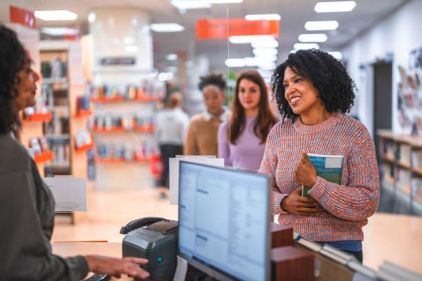 istock Diverse People Waiting In Line In A Library 1455947931