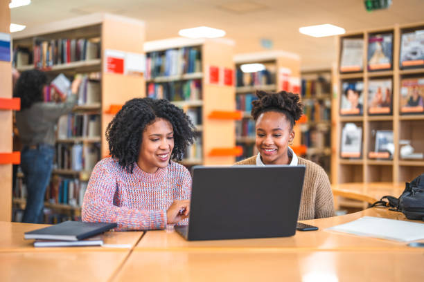 istock Female Hispanic Professor And A Student In A Library 1455948066