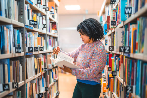 istock Hispanic Female In 30s Flipping through A Book 1455948085