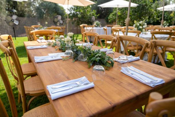 istock Tables under the white parasols decorated with delicate bouquets prepared for the wedding ceremony 1455948112