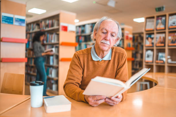 istock Caucasian Male In 60s Reading In A Library 1455948124