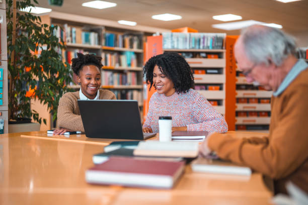 istock Hispanic Females Studying In A Library Using Laptop 1455948133