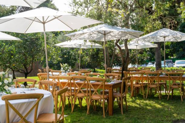 istock Tables under the white parasols decorated with delicate bouquets prepared for the wedding ceremony 1455948200