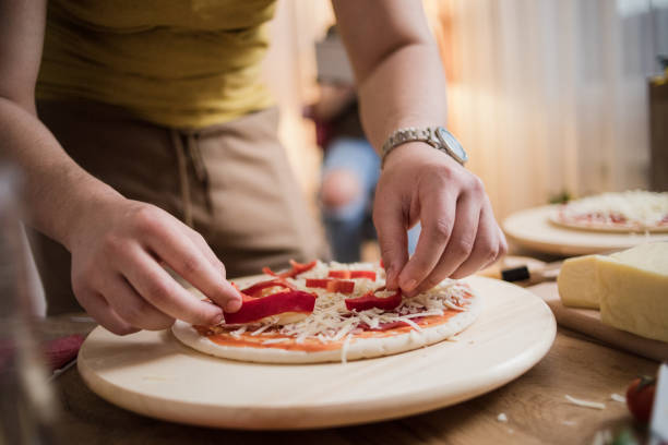istock A young couple in love is making pizza in the kitchen 1455948318
