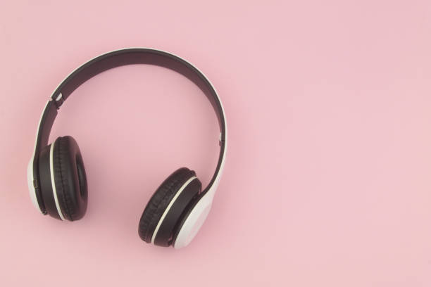 istock Wireless headphones on pink background 1455950713