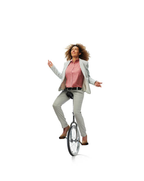 マルチタスクビジネスウーマン - unicycle unicycling cycling wheel ストックフォトと画像