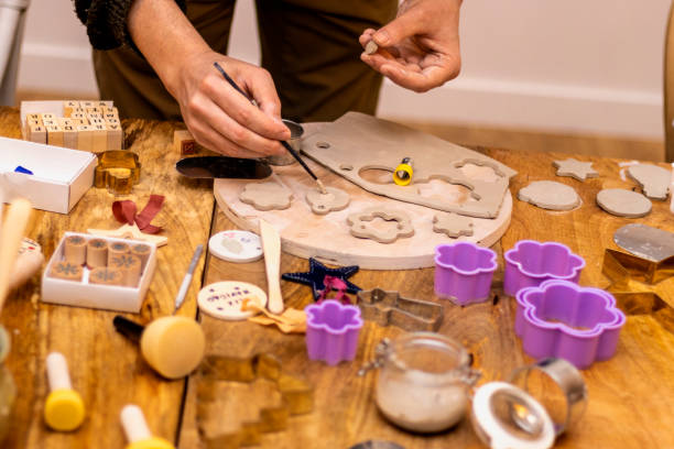 istock Ceramics workshop. Man working wet clay with brushes. 1455954927