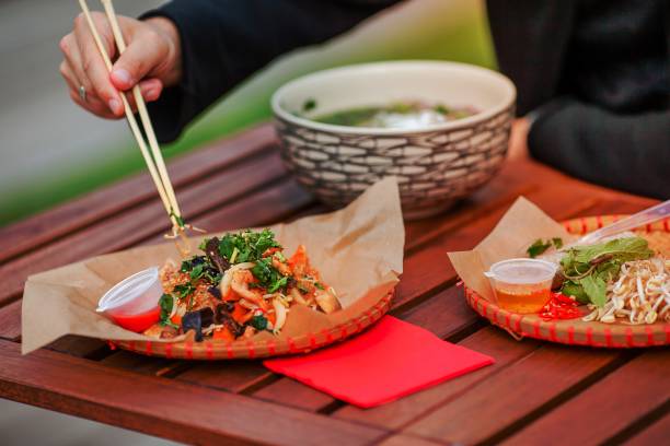 Asian rice noodles with vegetables and sause close-up on the table