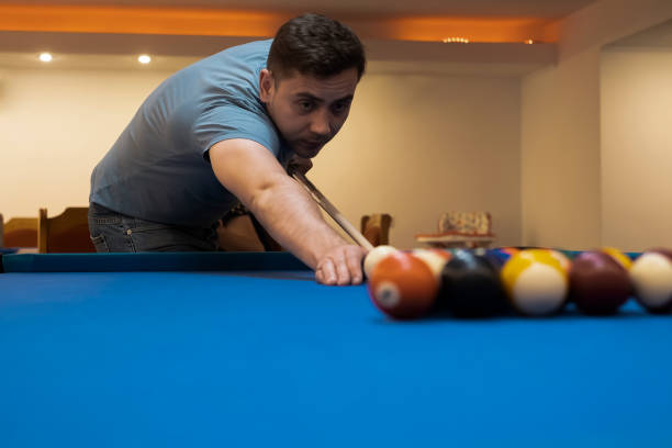 istock man holding hand on pool table, playing snooker or getting ready to shoot billiard balls, snooker billiards port game, billiard balls 1455958104