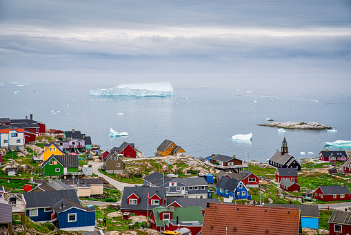 Aerial view of Ilulissat with icebergs floating in the background