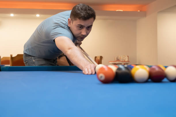 istock man holding hand on pool table, playing snooker or getting ready to shoot billiard balls, snooker billiards port game, billiard balls 1455958255