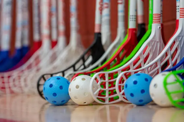 A selective focus shot of floorball sticks with balls