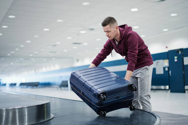 istock Suitcase in baggage claim in airport terminal 1455958635